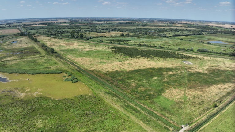 An aerial view of Burwell Fen and surrounding landscape, showing scrub, grassland and waterways